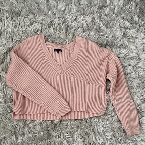 a light pink sweater